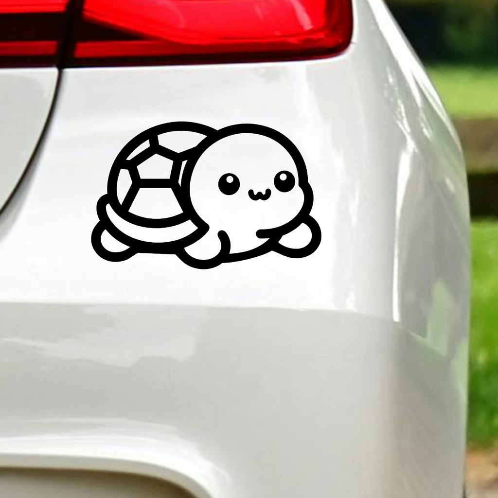 Black baby turtle sticker on white car bodywork.