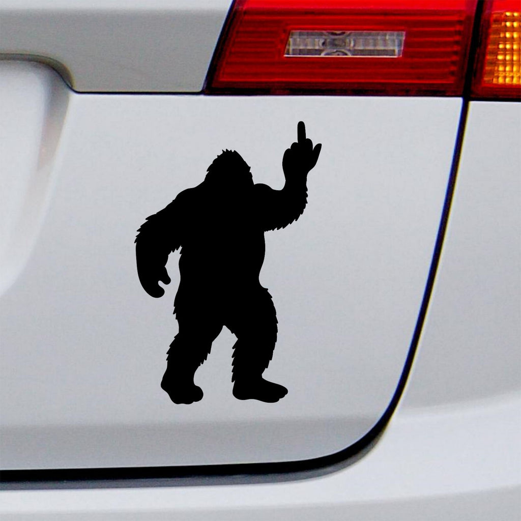 Black bigfoot middle finger decal on a white vehicle tailgate.