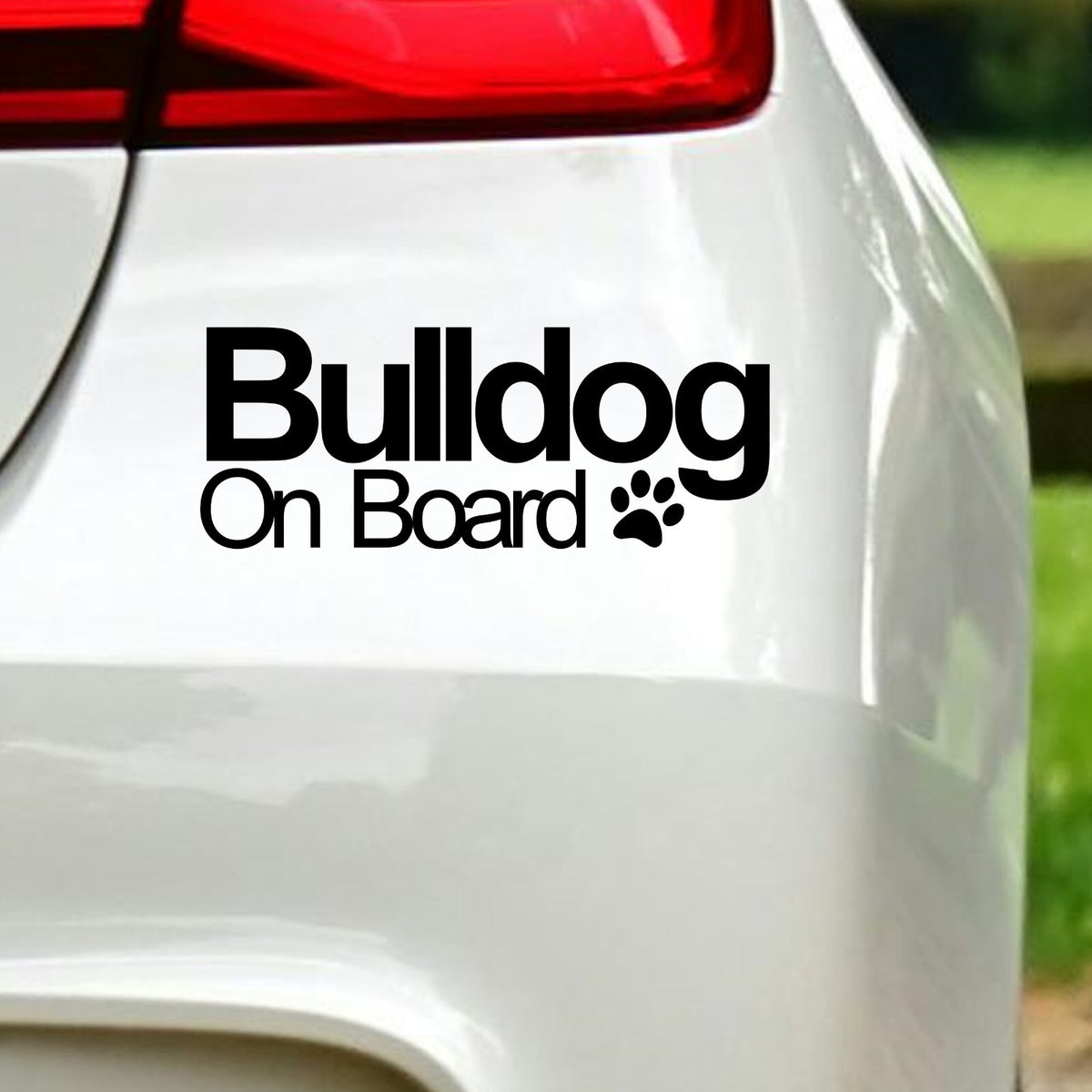Black Bulldog On Board decal below the rear light of a white car.
