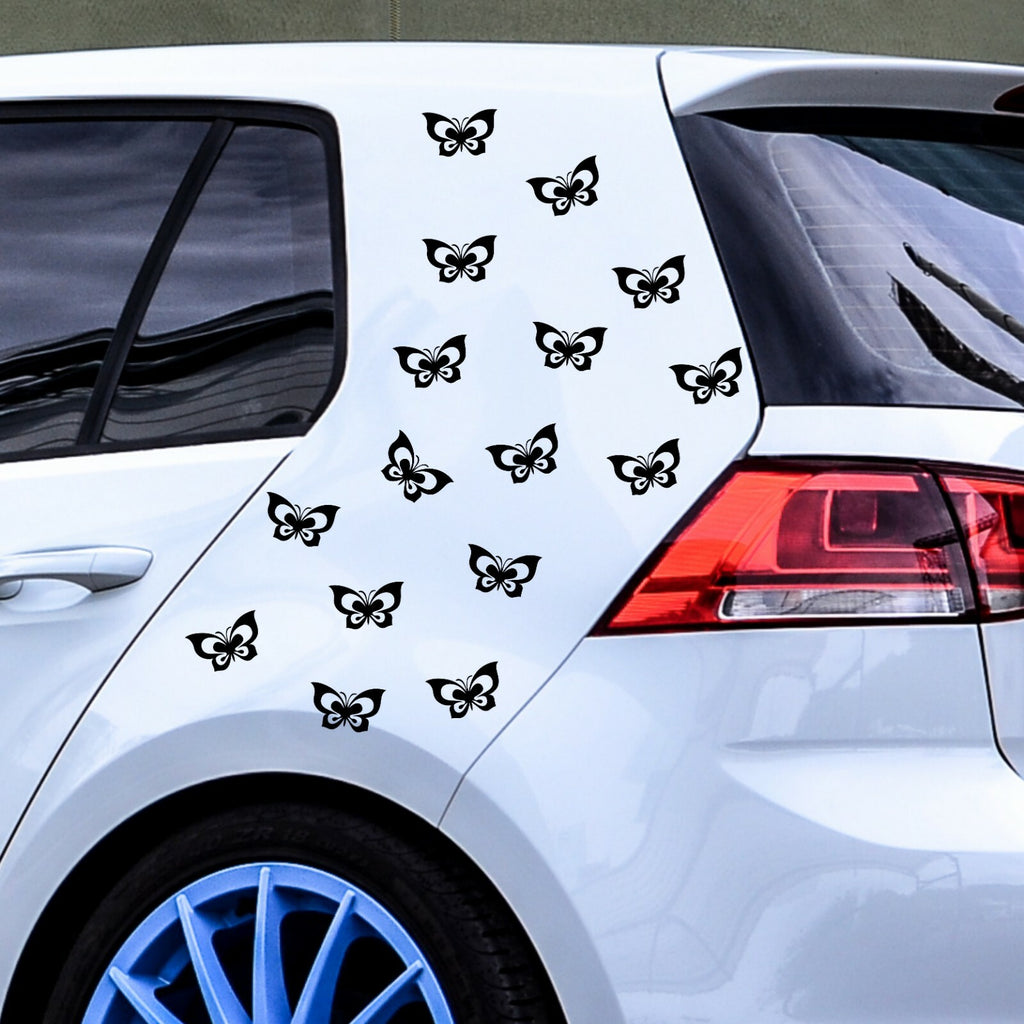 Black butterfly stickers arranged on a white car.