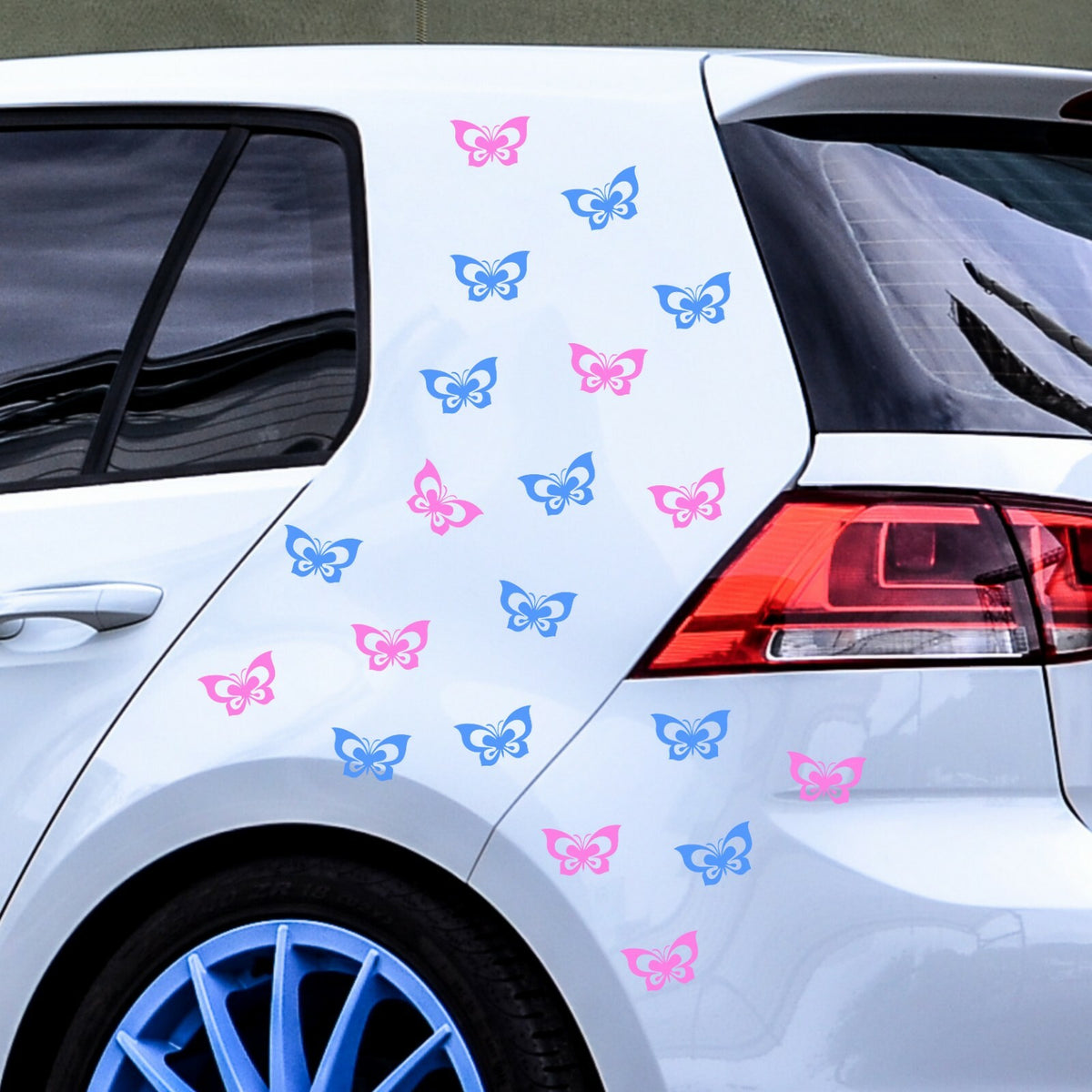 Light blue and light pink butterfly stickers on a white car.