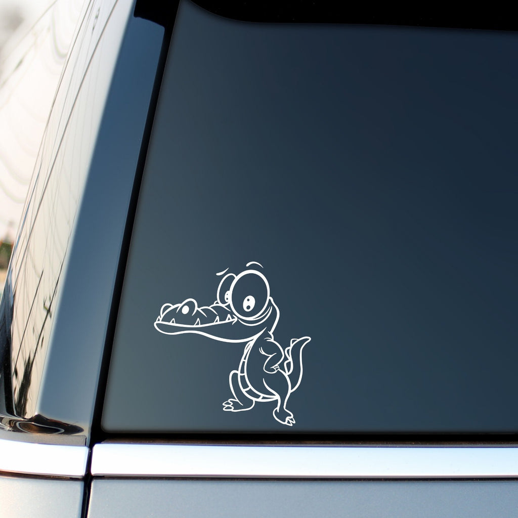 White cartoon crocodile sticker on a vehicle side window.