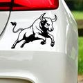 Black charging bull sticker on white car bodywork beneath a rear light.
