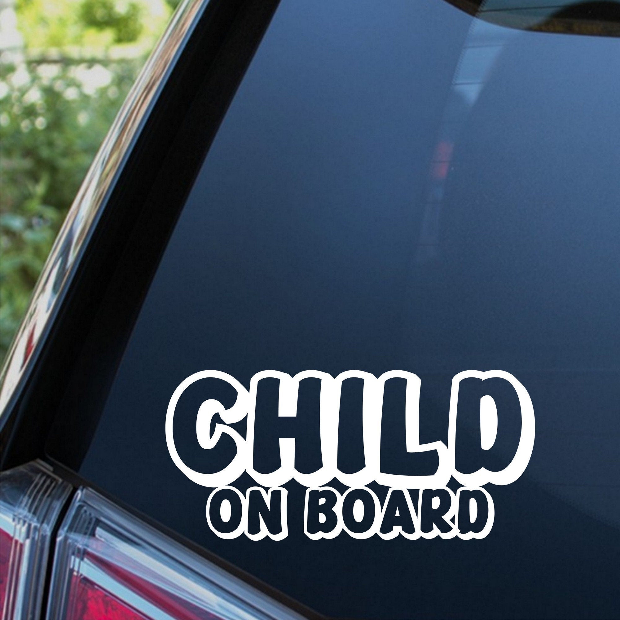 Child On Board outline car sticker shown on a dark vehicle window