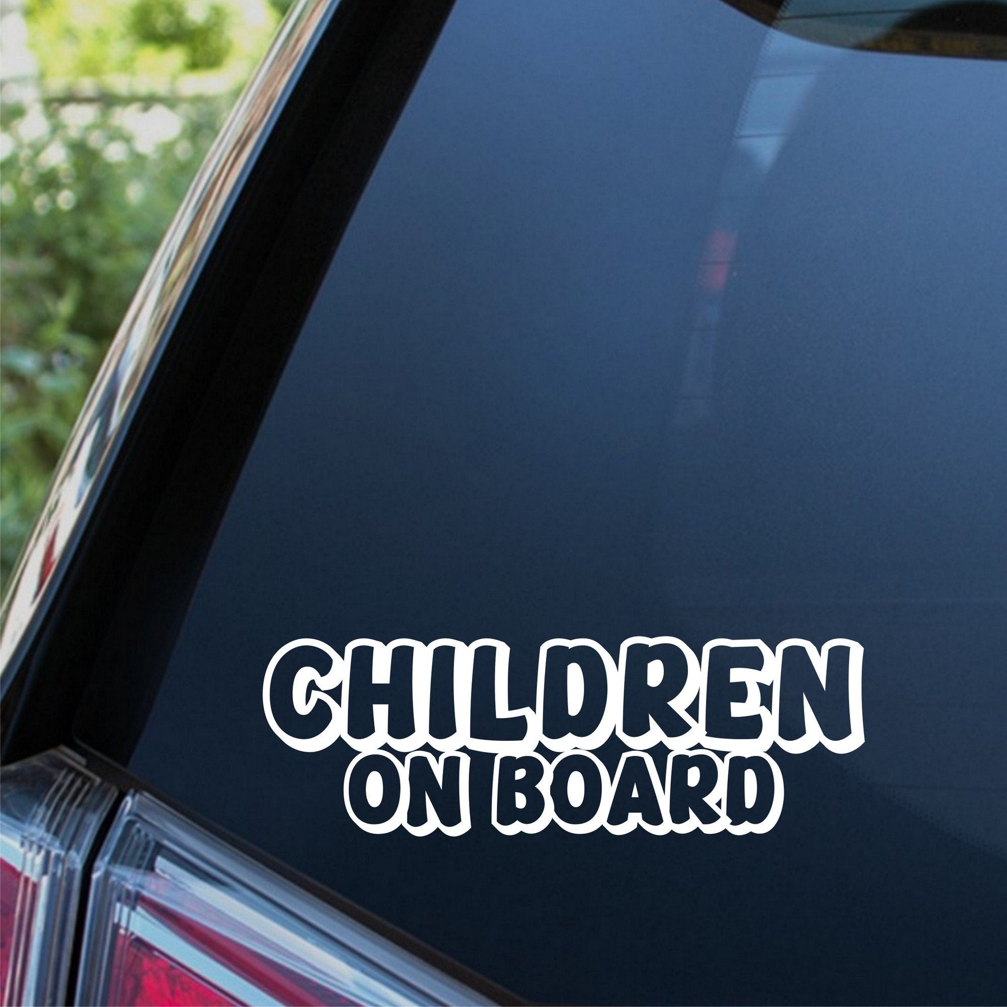 Children On Board outline car sticker shown on a dark vehicle window