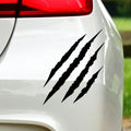 Black claw scratch marks sticker on white car bodywork beneath a rear light.