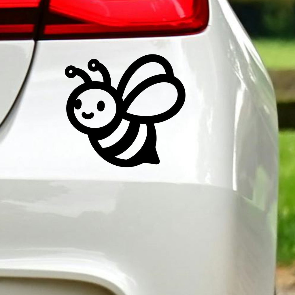 Black cute smiling bee sticker on white car bodywork.