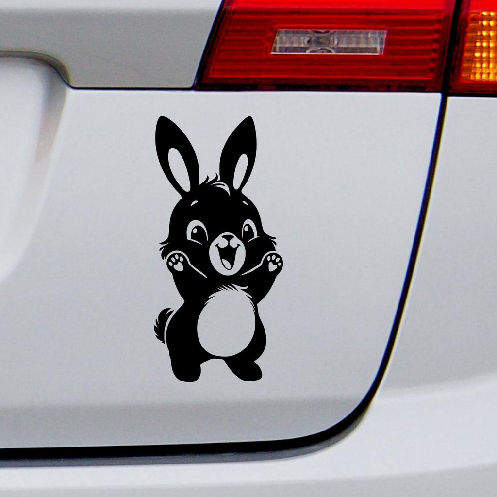 Black cute bunny rabbit decal on a white vehicle tailgate.