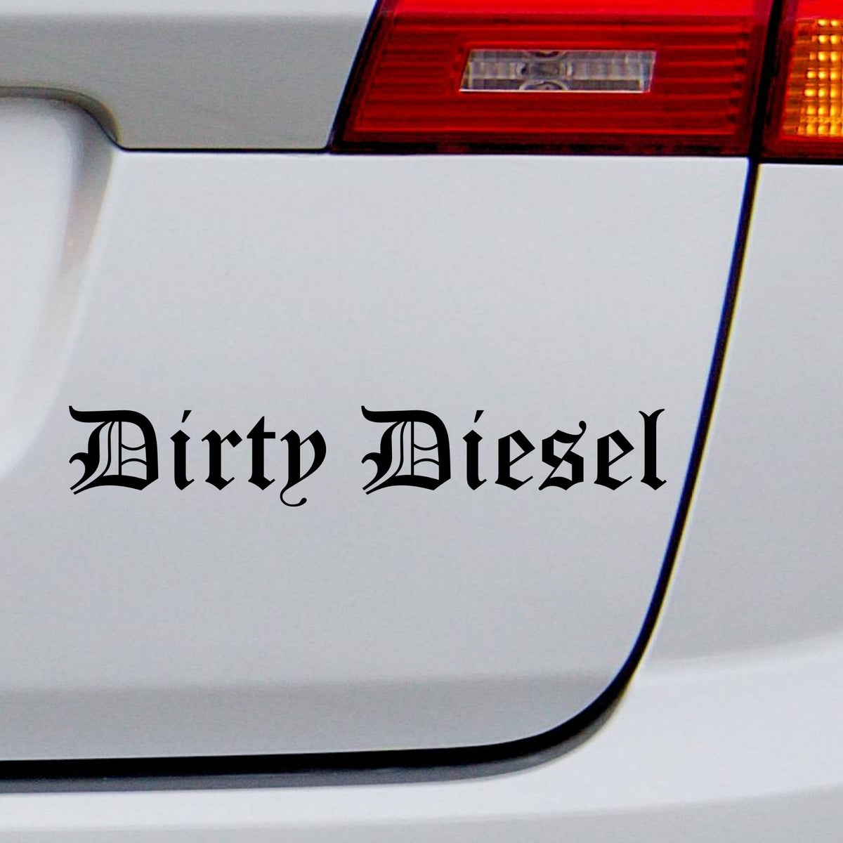 Black Dirty Diesel gothic car sticker on a white vehicle tailgate beneath a rear light.