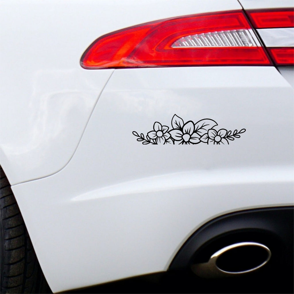 Black floral flower border sticker on a white car bumper.