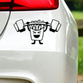Black french fries barbell sticker on white car bodywork beneath a rear light.