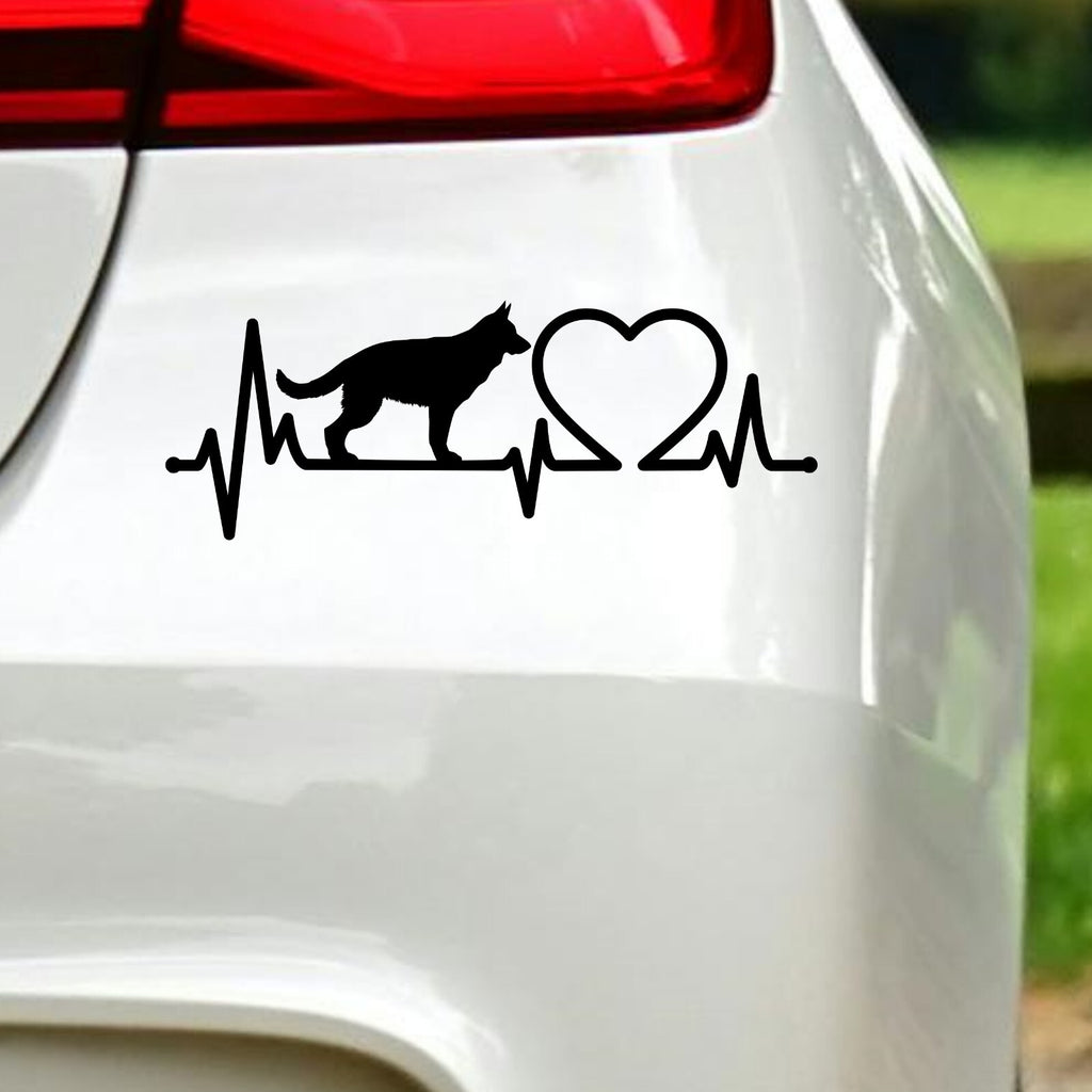 Black german shepherd heartbeat sticker on white car bodywork beneath a rear light.