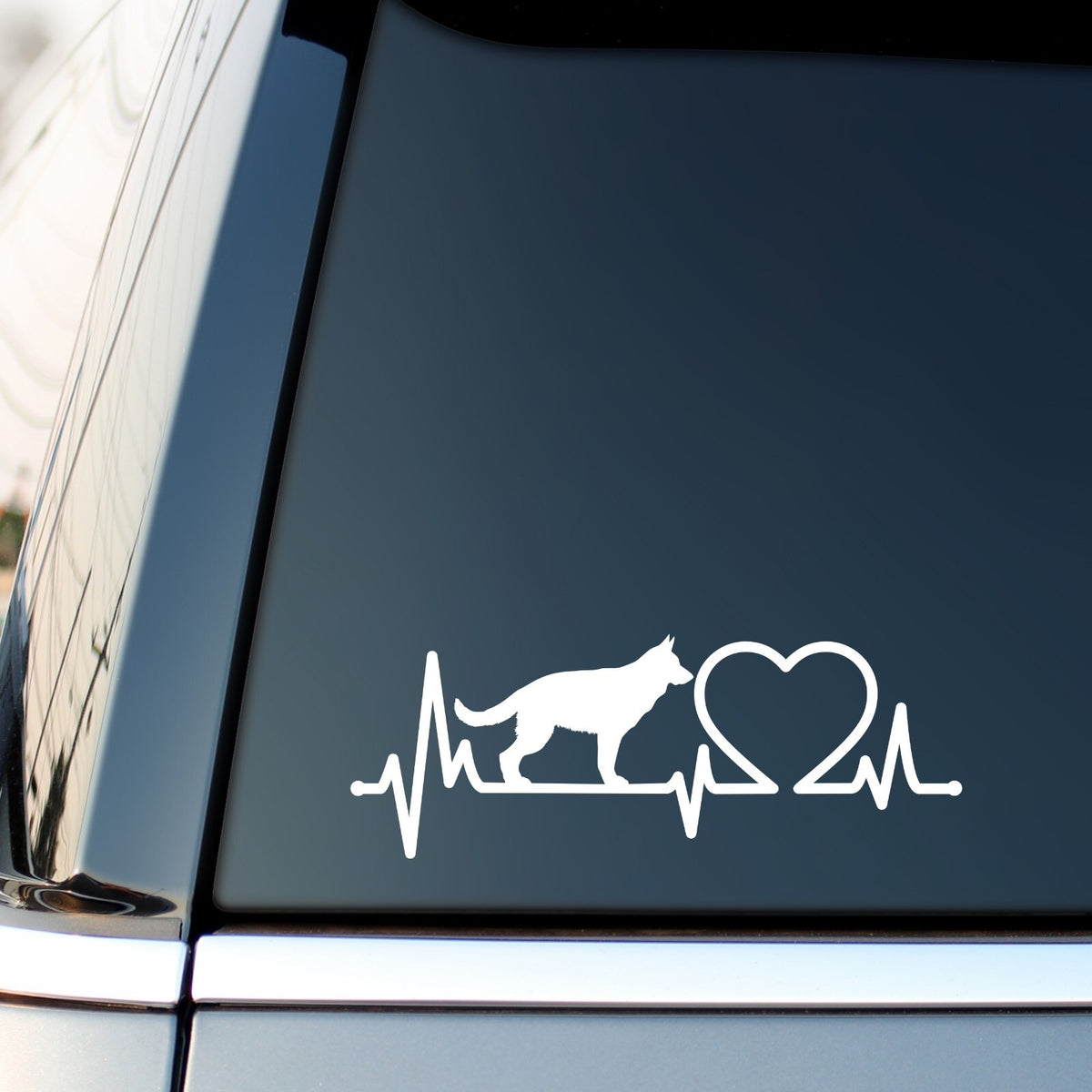 White german shepherd heartbeat sticker on a vehicle side window.