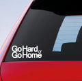 White Go Hard Or Go Home stacked lettering sticker on a red car window.