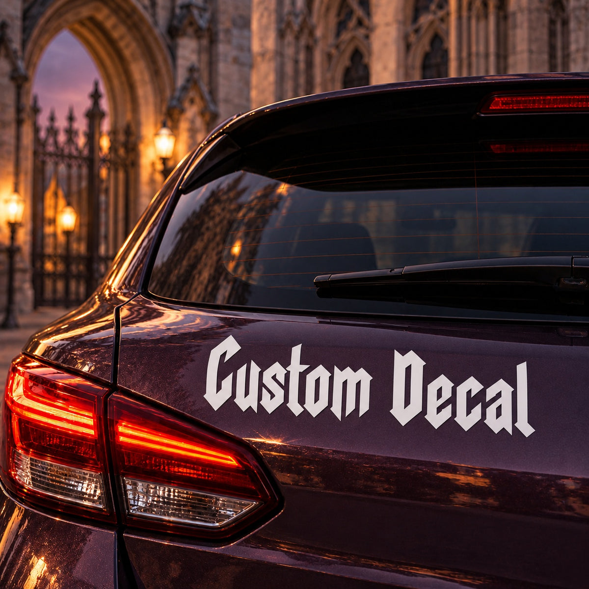 White Custom Decal Gothic lettering applied to the rear bodywork of a plum hatchback.