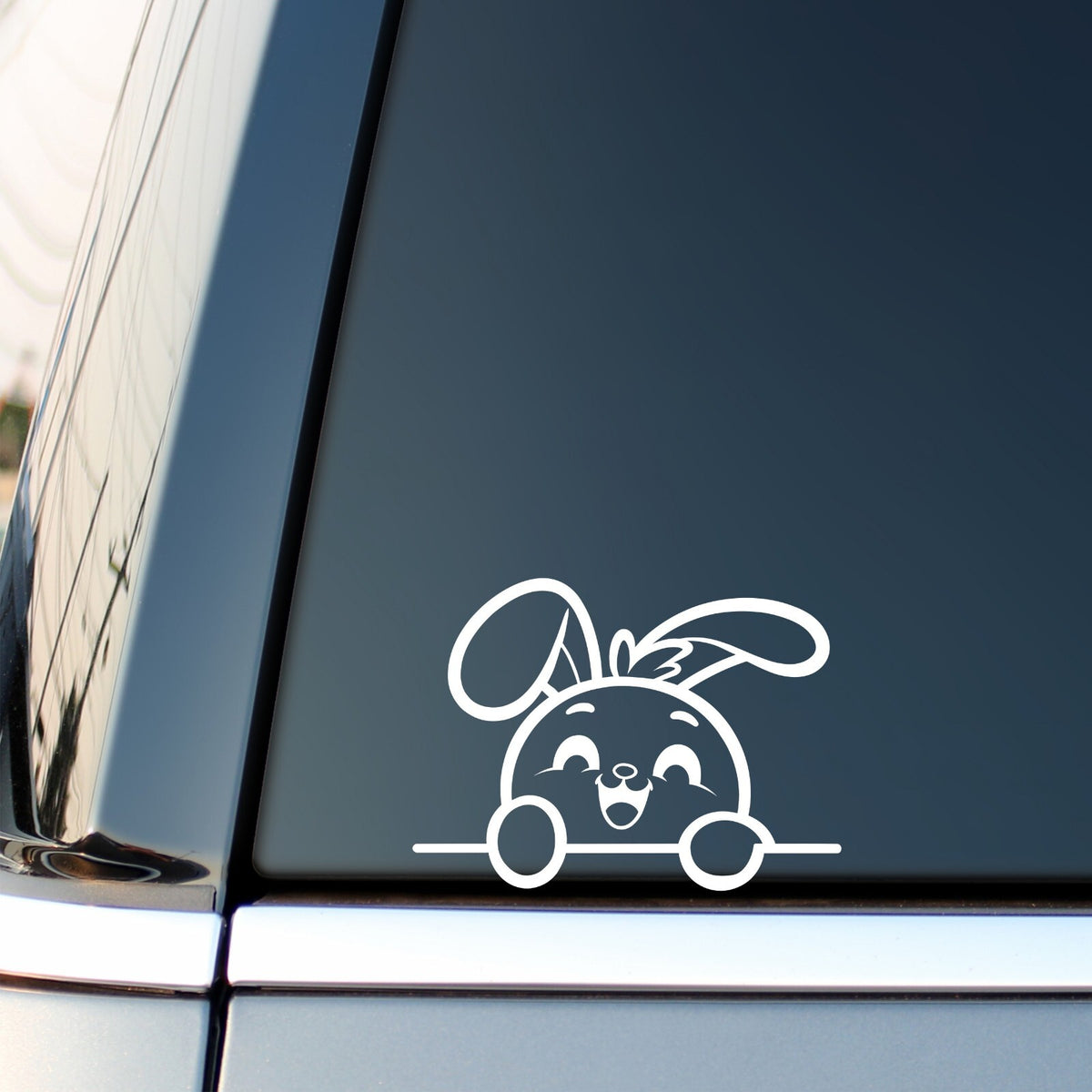 Happy Peeking Bunny vinyl sticker — white decal on a vehicle window.