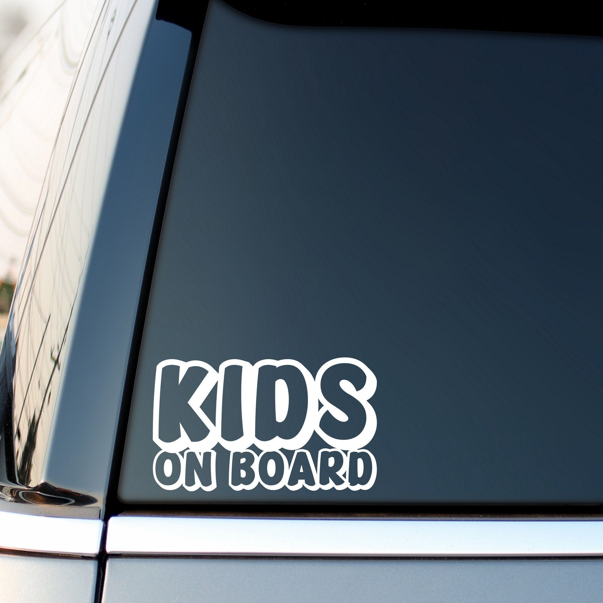 Kids On Board outline car sticker shown on a vehicle rear window
