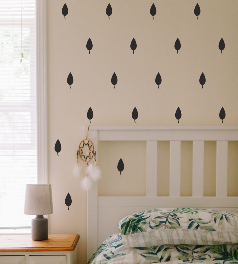 Leaf wall stickers displayed above a headboard