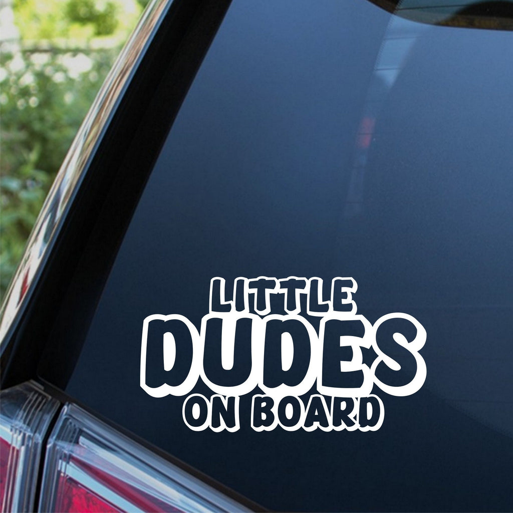 Little Dudes On Board outline car sticker shown on a dark vehicle window