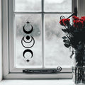 Black moon and star witch symbols sticker on a window.