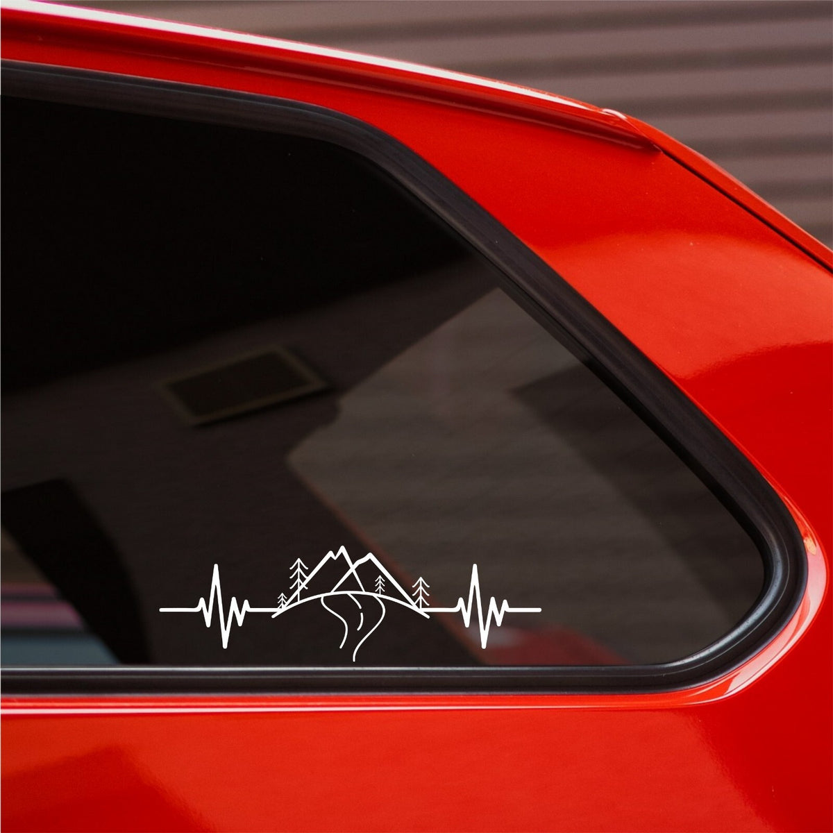 White Mountain Heartbeat decal on the rear side window of a red car.