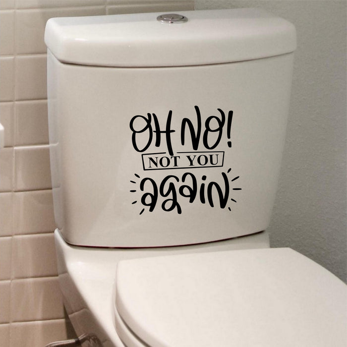 Black Oh No Not You Again sticker on a white toilet cistern.