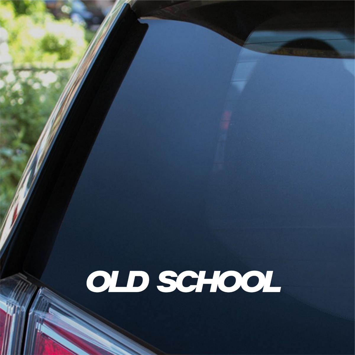 White Old School bold italic decal on a car rear window.