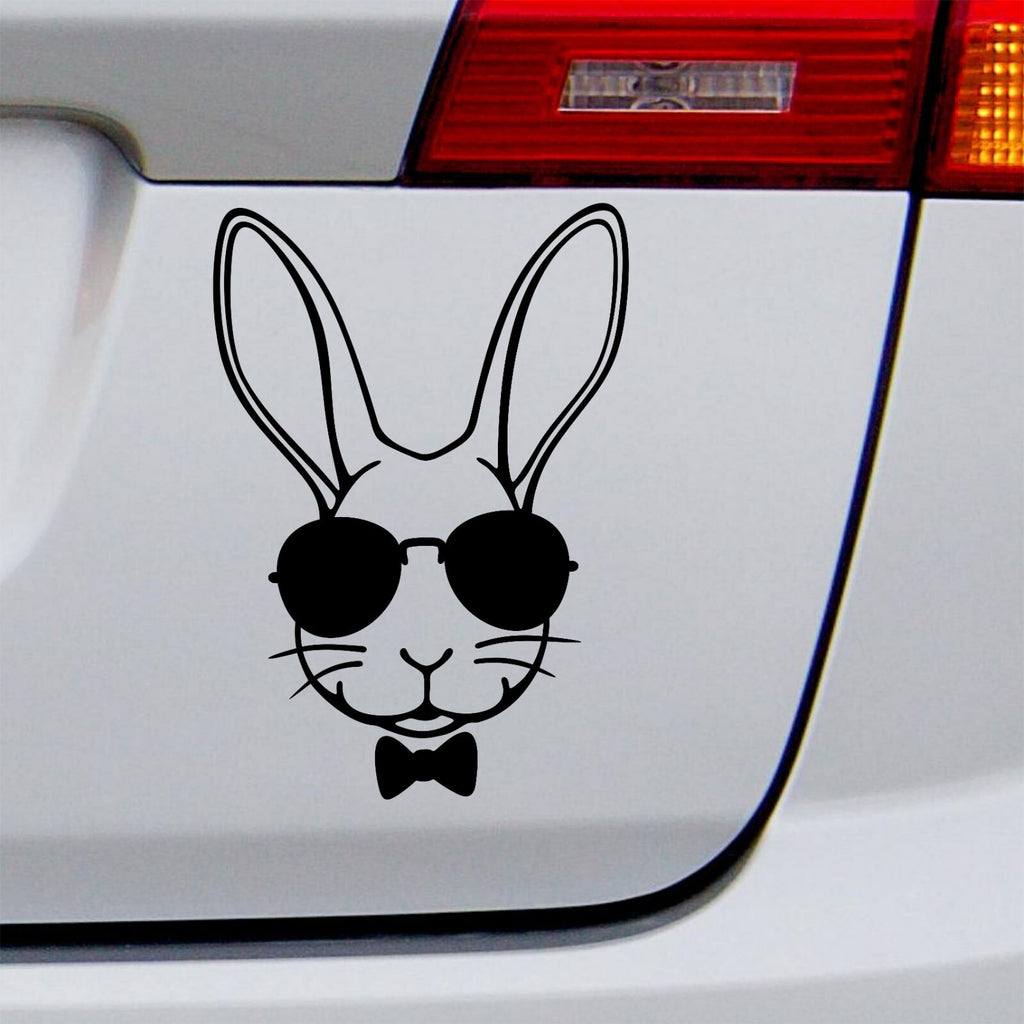 Black rabbit with sunglasses decal on a white vehicle tailgate.