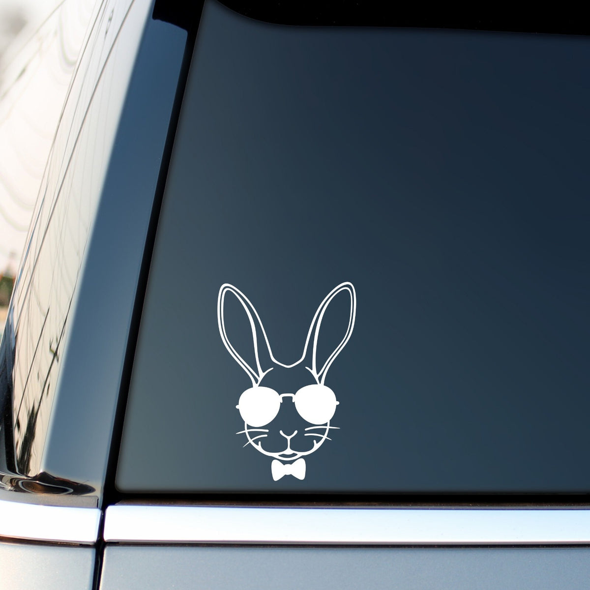 White rabbit with sunglasses sticker on a vehicle side window.