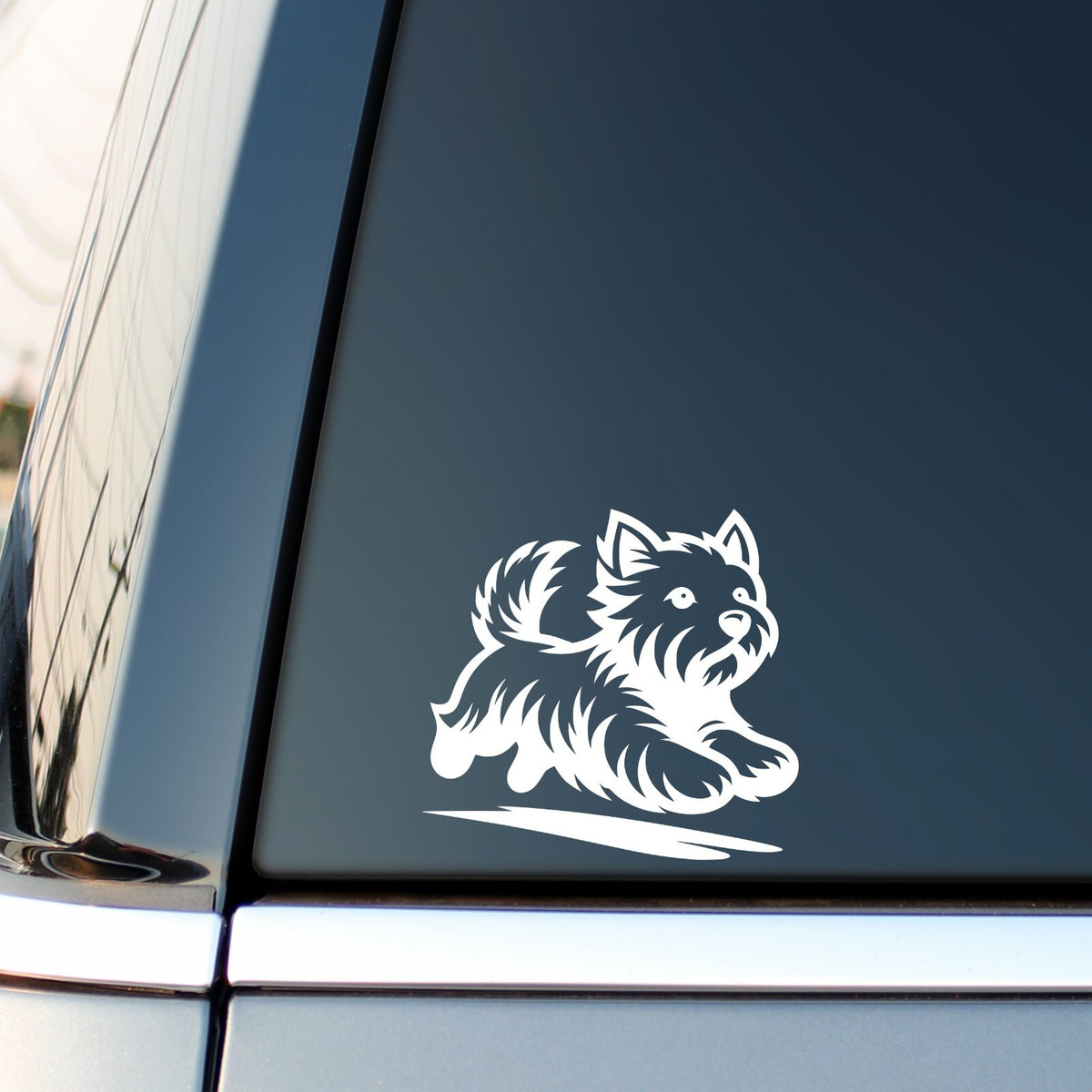 Running Westie vinyl sticker — white decal on a vehicle window.