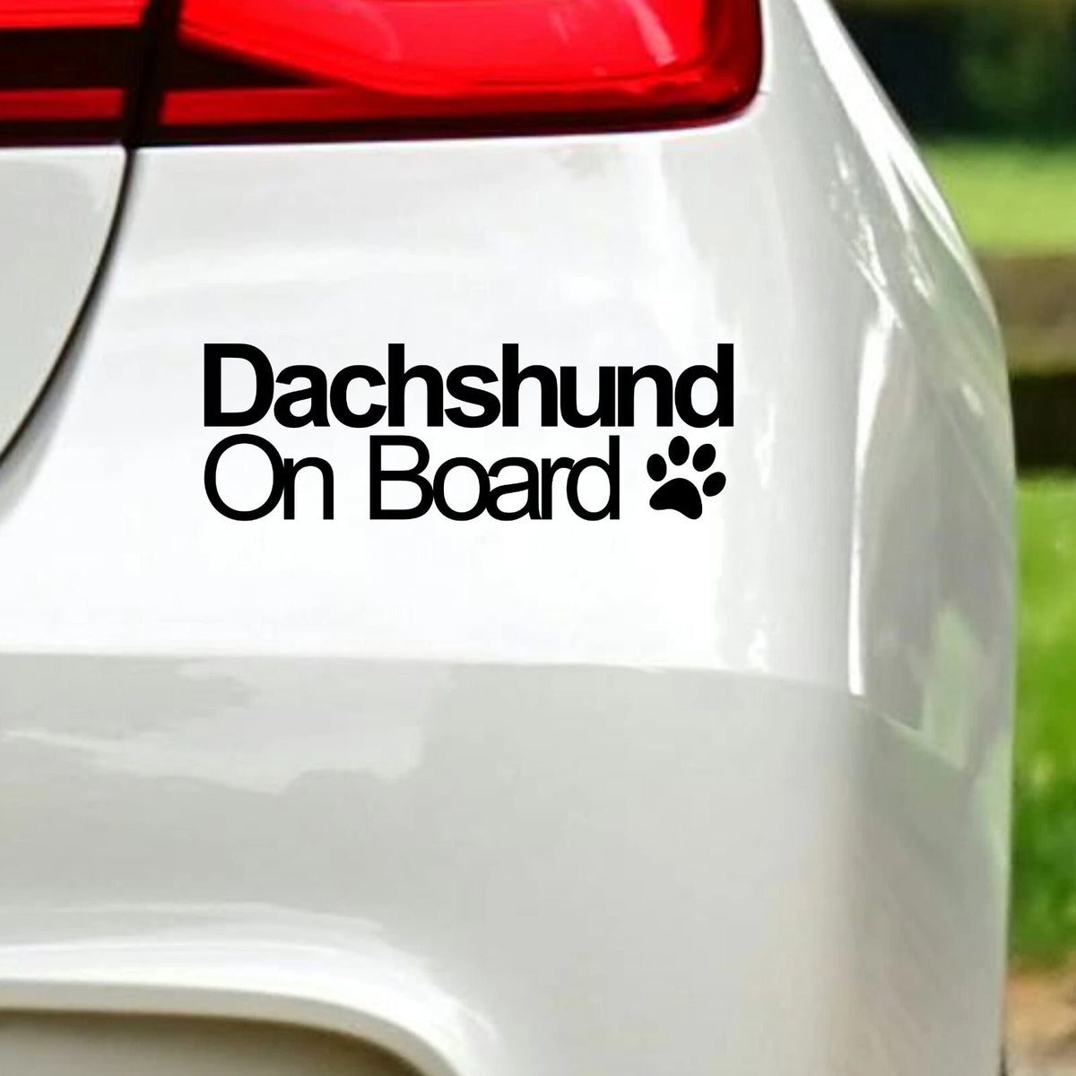Dachshund On Board vinyl car sticker shown fitted to a white vehicle.