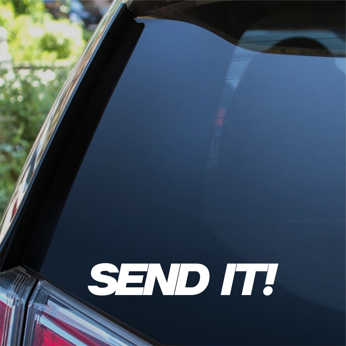 White Send It bold italic decal on a car rear window.