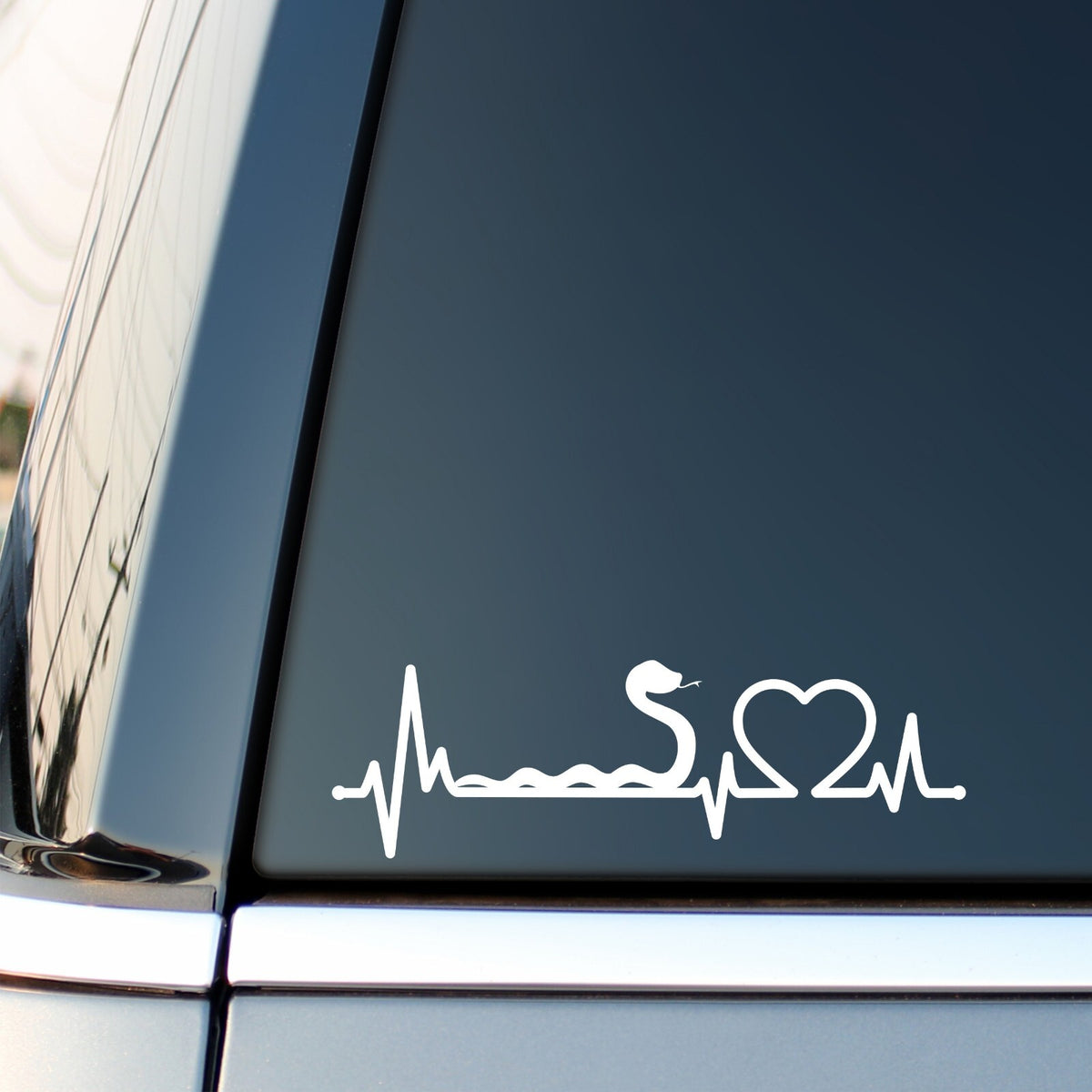White Snake Heartbeat decal on a car side window.