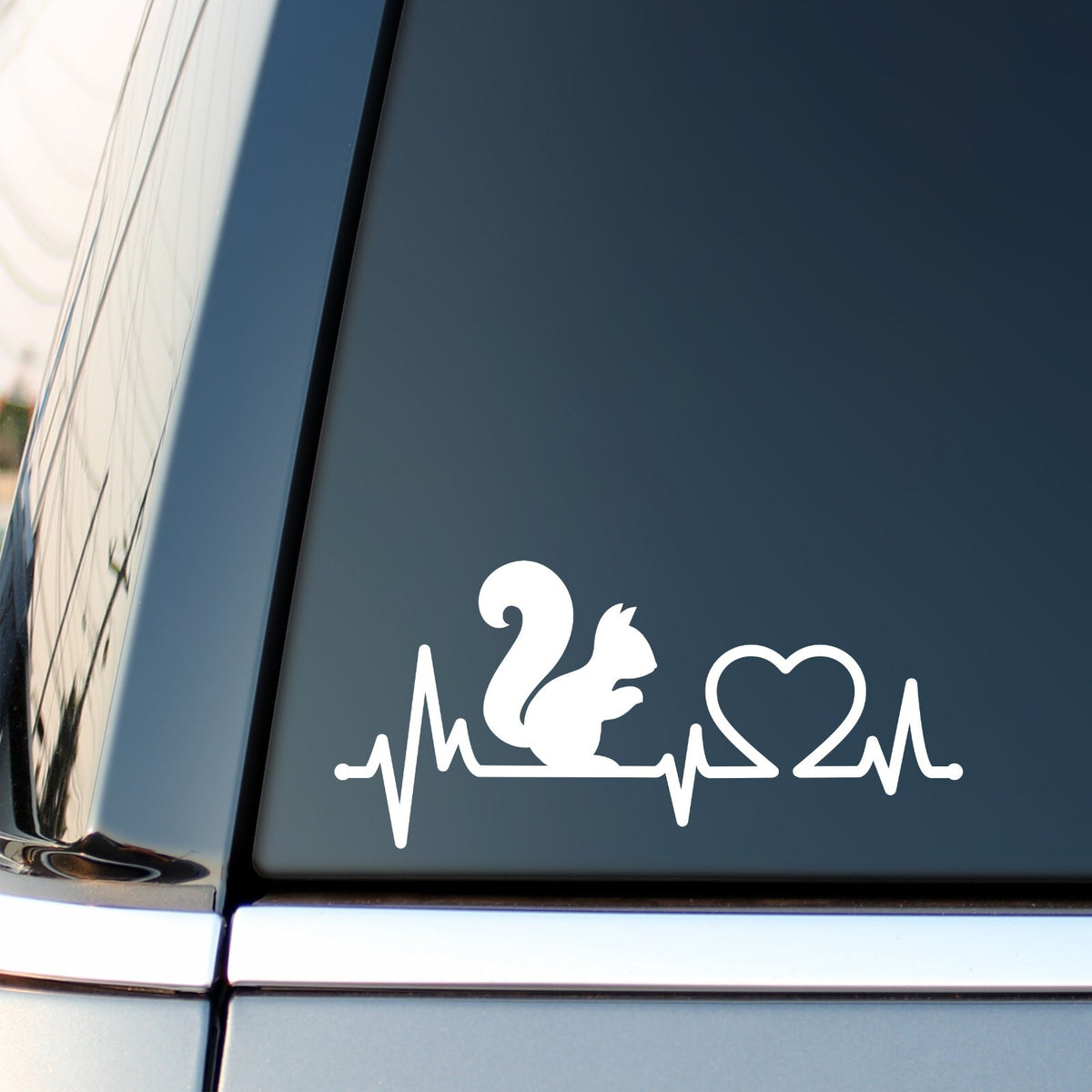 White Squirrel Heartbeat decal on a car side window.