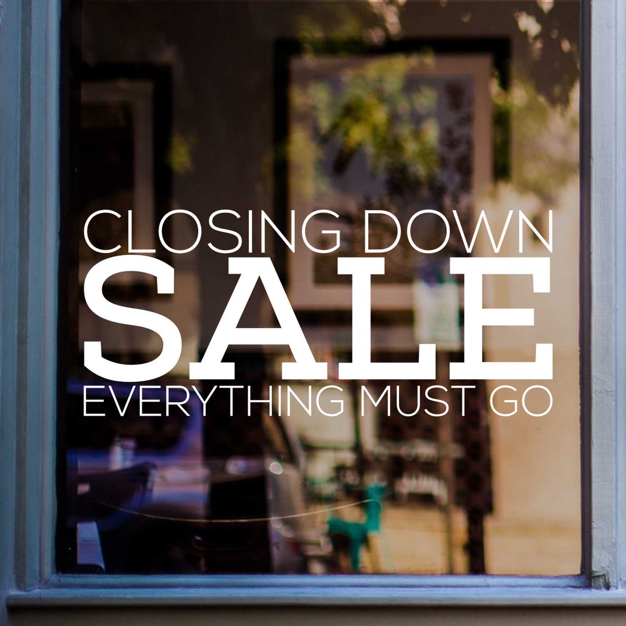 Closing Down Sale Window Sticker shown on a shop window