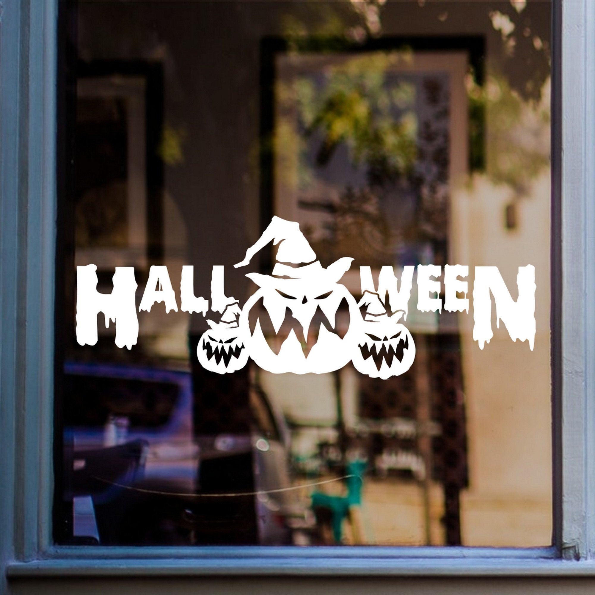 Halloween Pumpkin Parade Window Sticker shown on a shop window