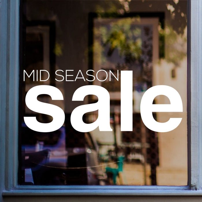 Mid Season Sale Shop Window Sticker displayed on a shop window