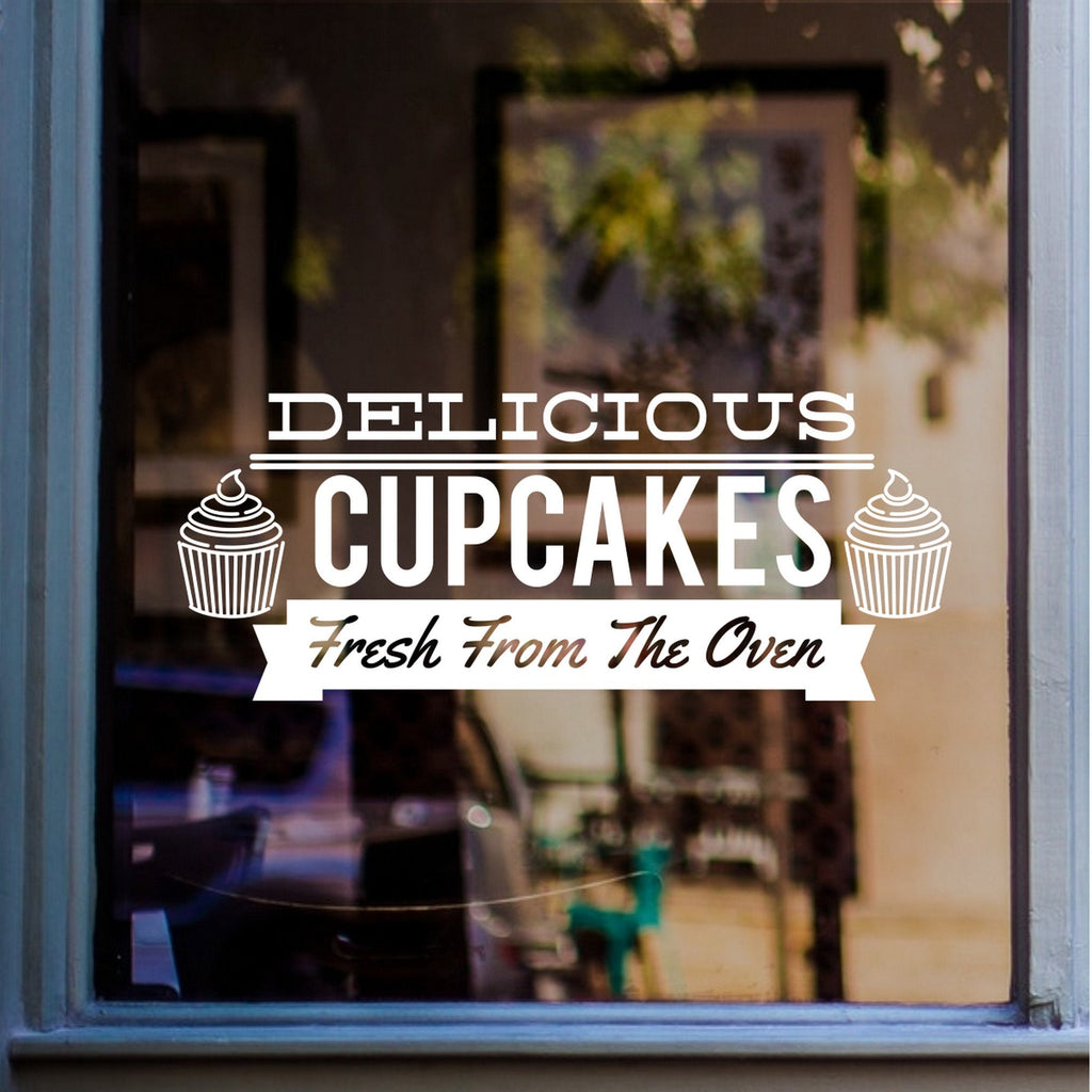 Delicious Cupcakes Bakery Window Sticker displayed on a shop window