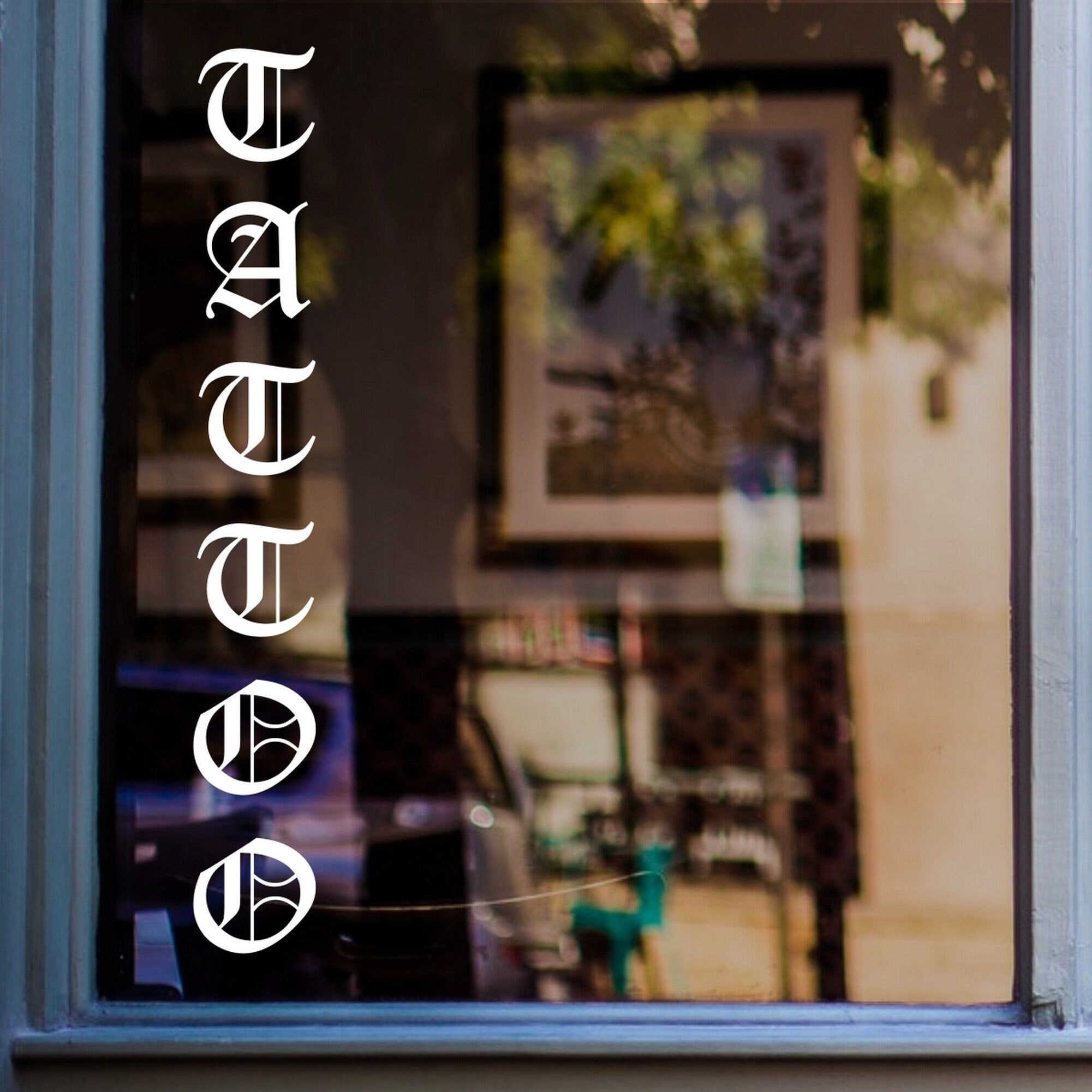 Tattoo Studio Lettering Window Sticker shown on a shop window