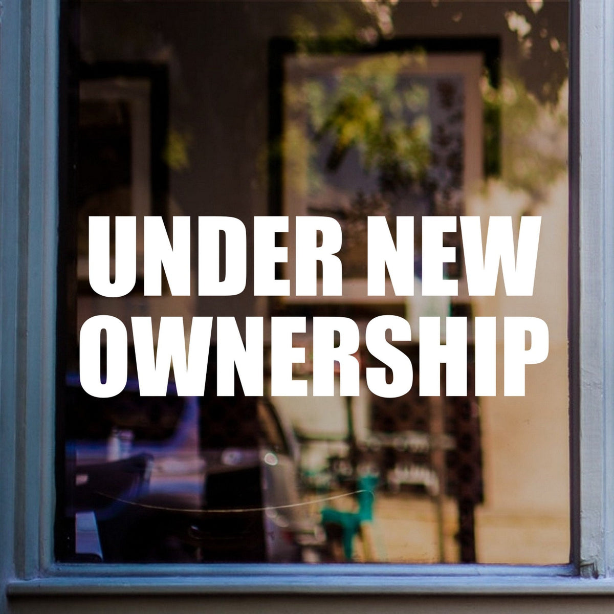Under New Ownership Shop Window Sticker displayed on a shop window