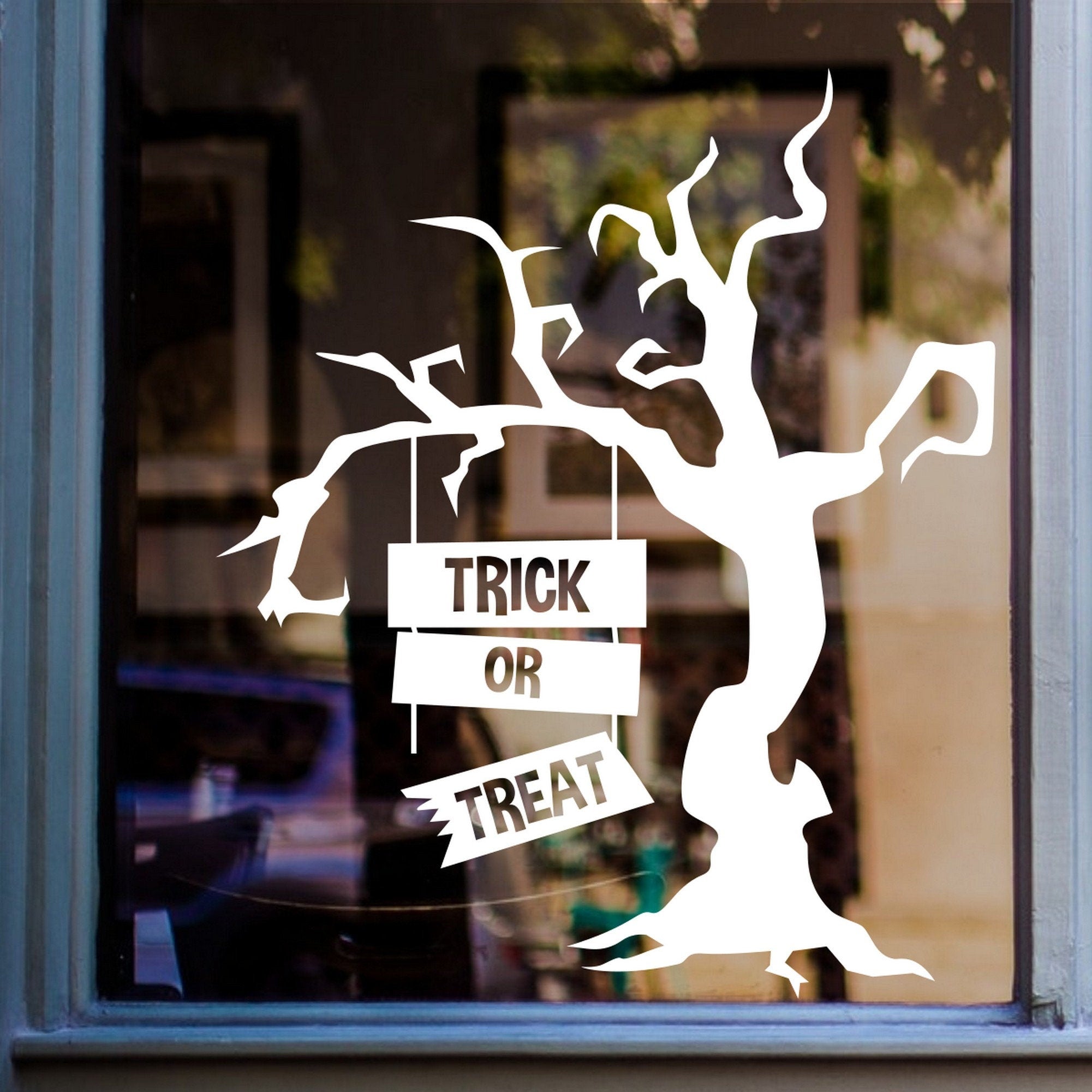 Trick or Treat Creepy Tree Window Sticker displayed on a window