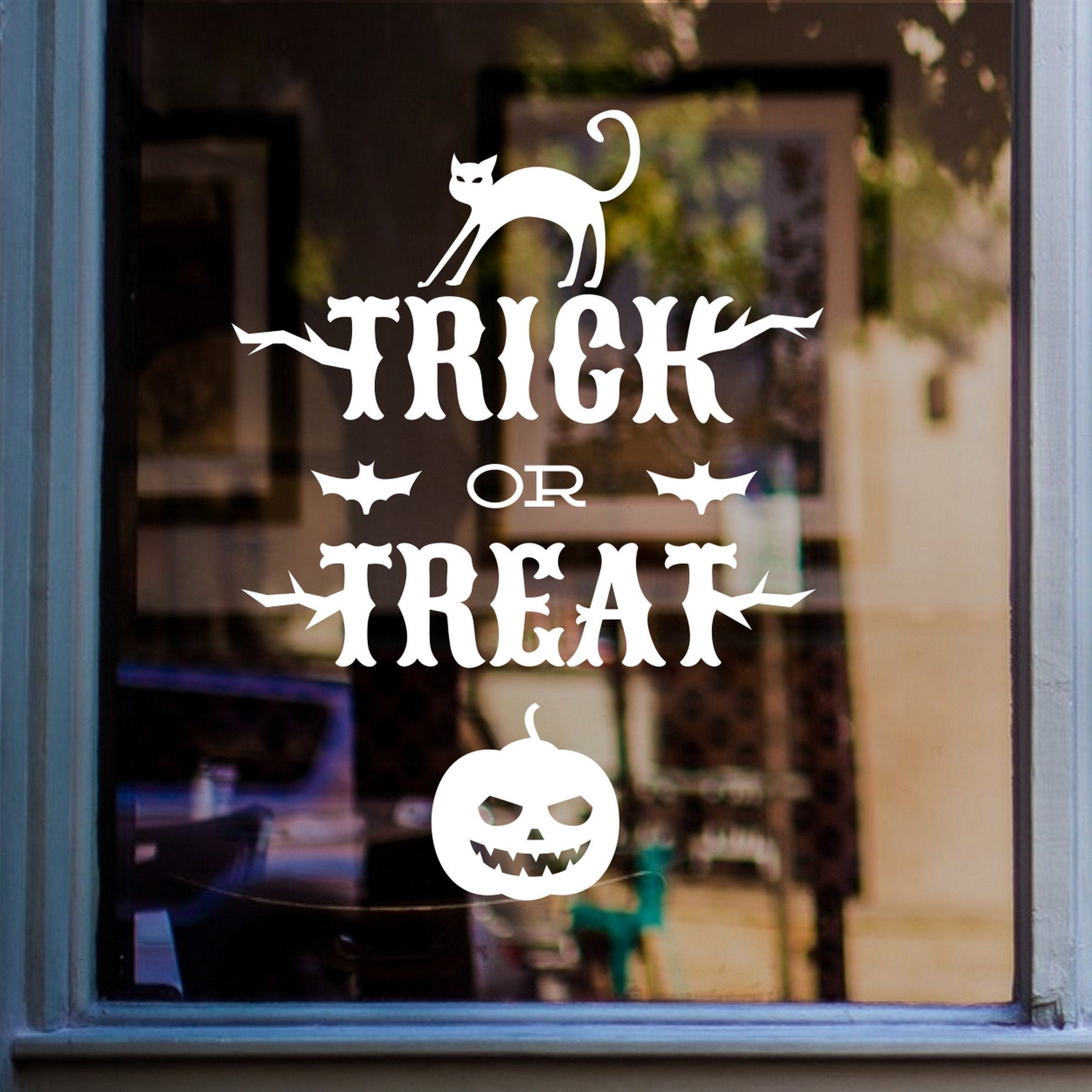 Trick or Treat Halloween Window Sticker shown on a shop window