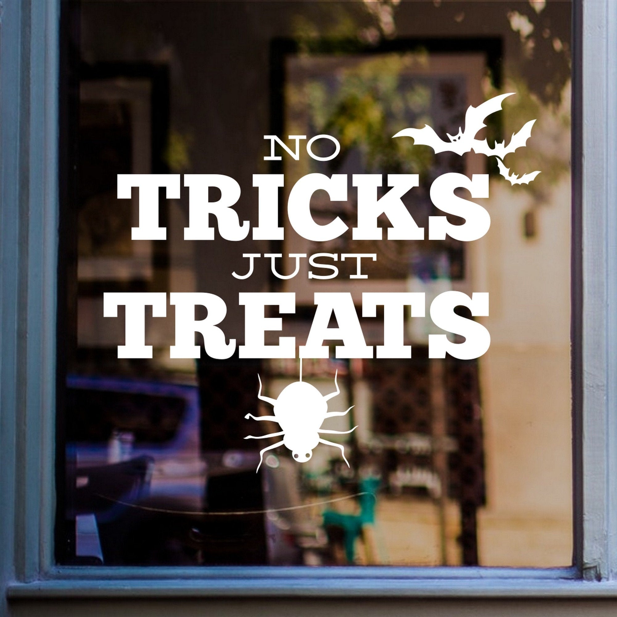 No Tricks Just Treats Halloween Window Sticker shown on a shop window