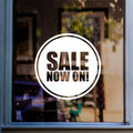 Sale Now On Window Sticker displayed on a window