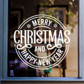 Merry Christmas window sticker with circular festive lettering displayed on shop glass.