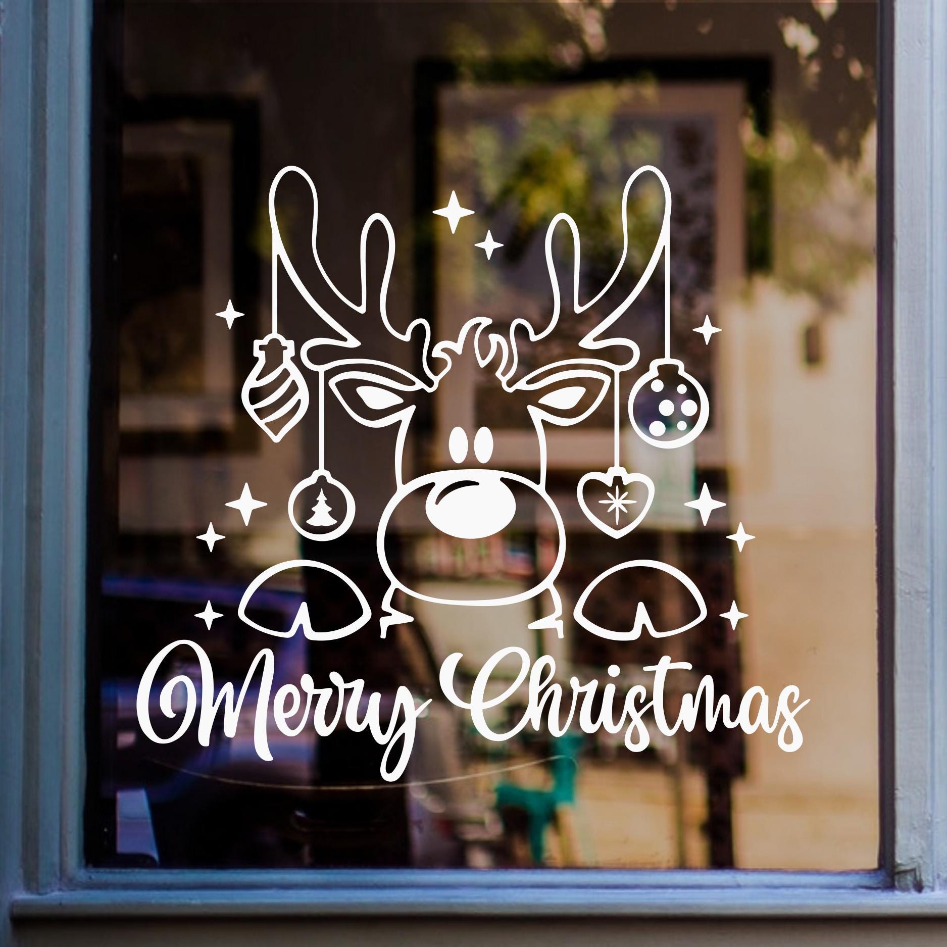 Merry Christmas reindeer window sticker featuring three festive reindeer faces displayed in white vinyl on glass.