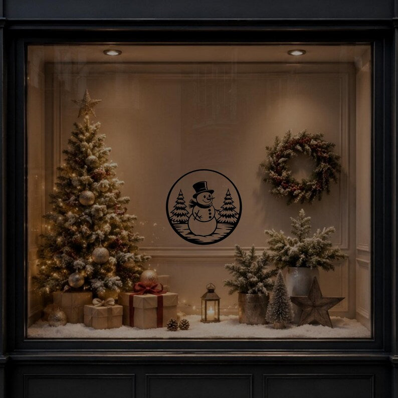 Christmas snowman and fir tree vinyl sticker shown on a dark festive window display.