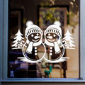 Christmas snowmen window sticker featuring two festive snowmen with winter hats, scarves and fir trees on glass.