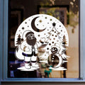 Santa and snowman Christmas window sticker with snowy trees, stars and a crescent moon displayed on glass.