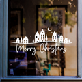 White Merry Christmas village window sticker with houses, trees, stars and crescent moon displayed on a shop window